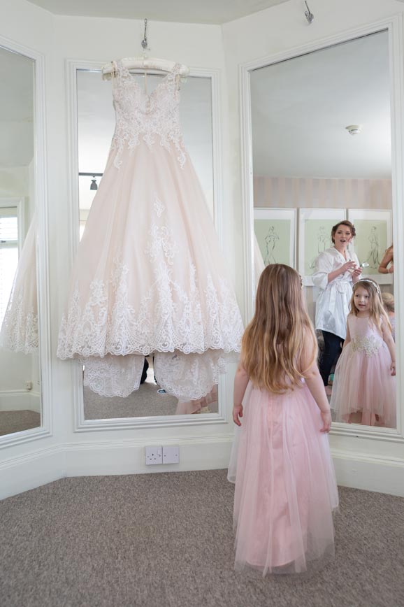 Flower girl checking out the brides dress in the Fennes bridal suite