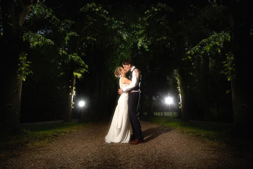 Bride and groom under the trees at Colville Hall
