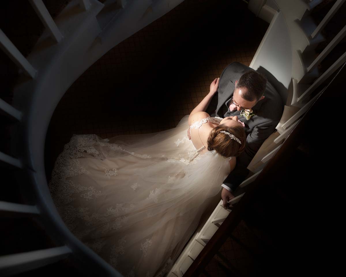 Bride and groom by the Fennes staircase