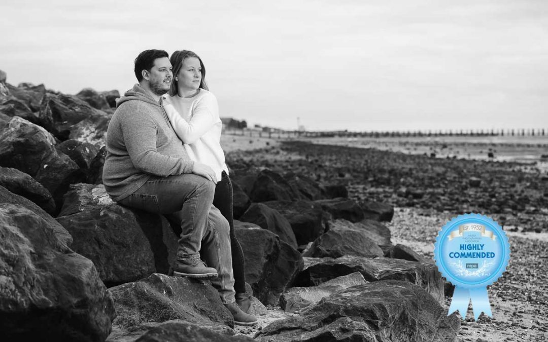 Engaged couple on the beach at Shoeburyness Seafront in Essex