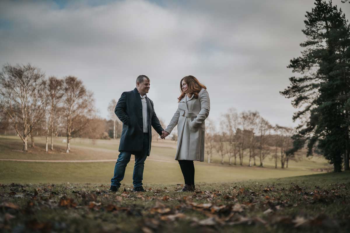 Engaged couple in the grounds at Stoke By Nayland Golf club