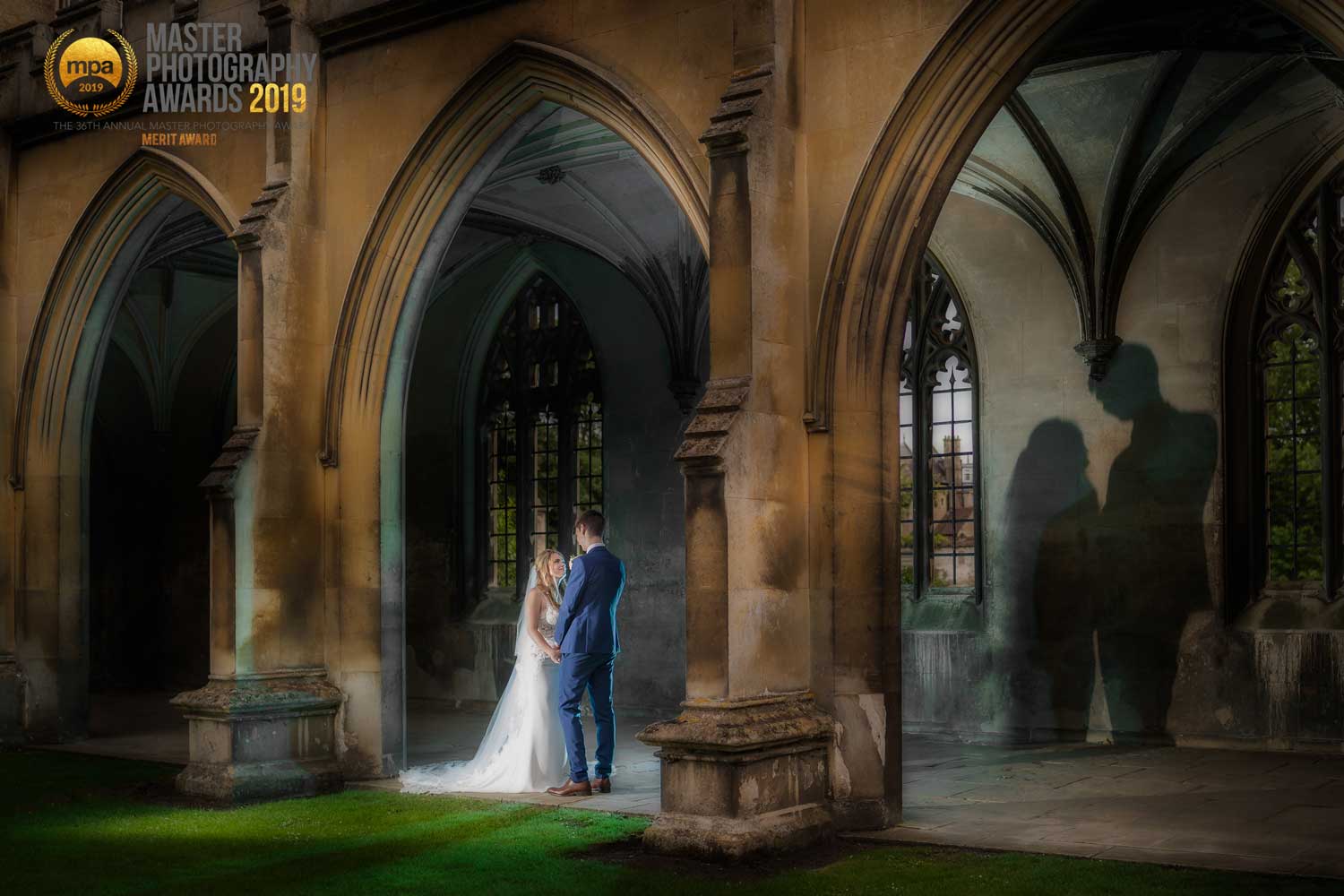Newly married couple casting their shadow on the wall at St Johns College, Cambridge
