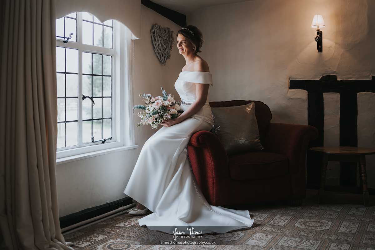 Bride elegantly looking out the window