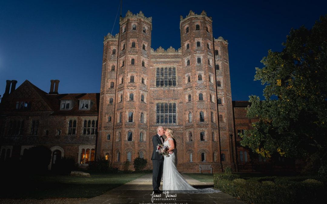 Bride and Groom at night outside Layer Marney Tower